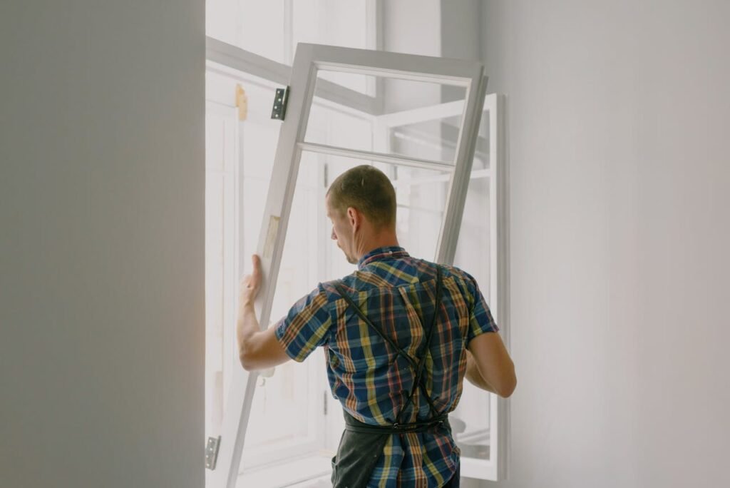 pexels-photo-5691531 Unrecognizable workman installing window in house during renovation process
